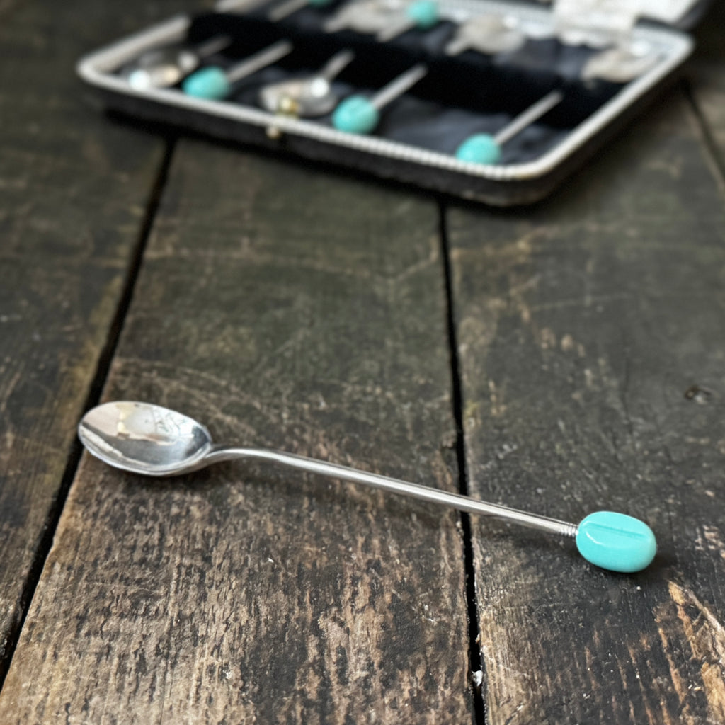Mid-century coffee spoons with stylised turquoise espresso bean terminals