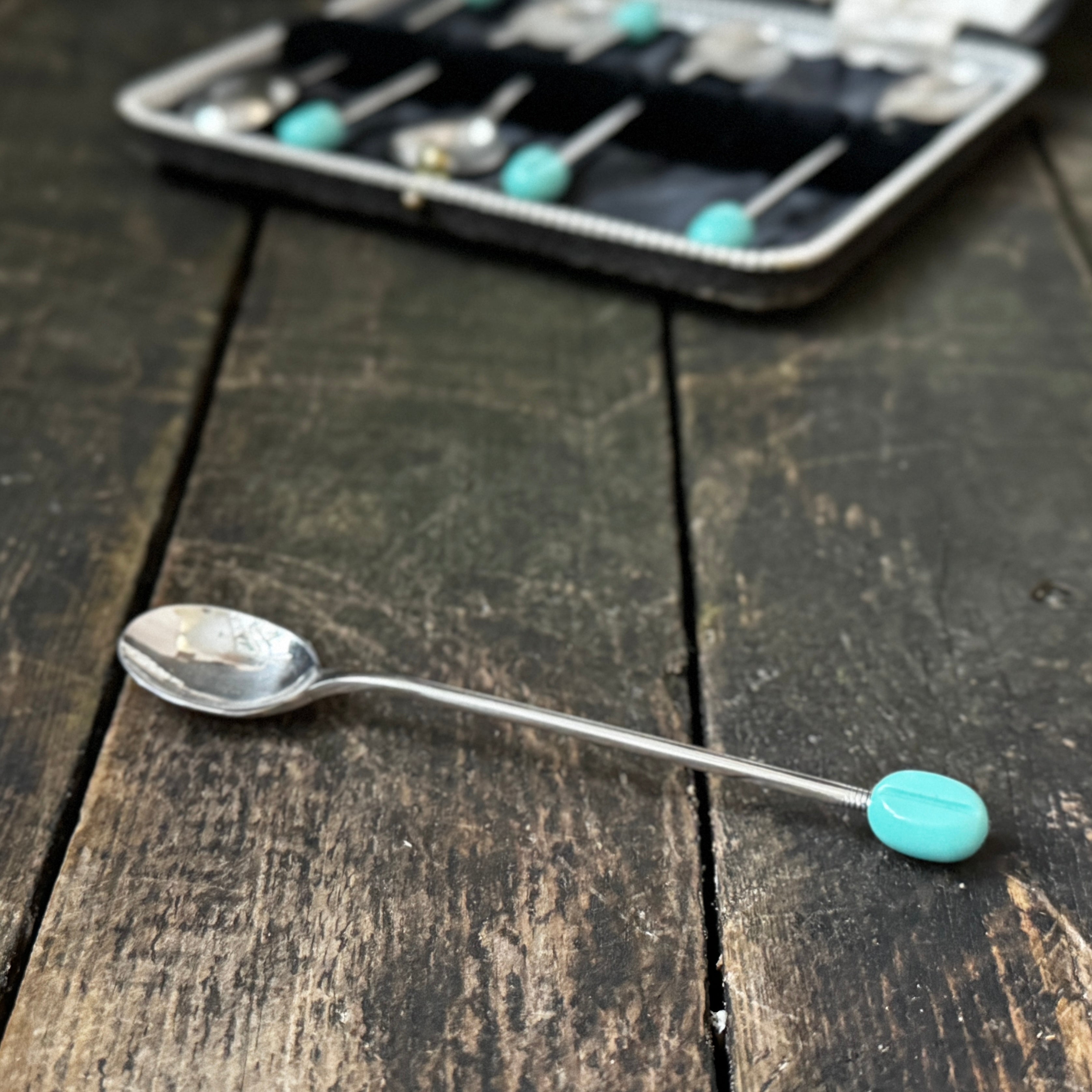 Mid-century coffee spoons with stylised turquoise espresso bean terminals