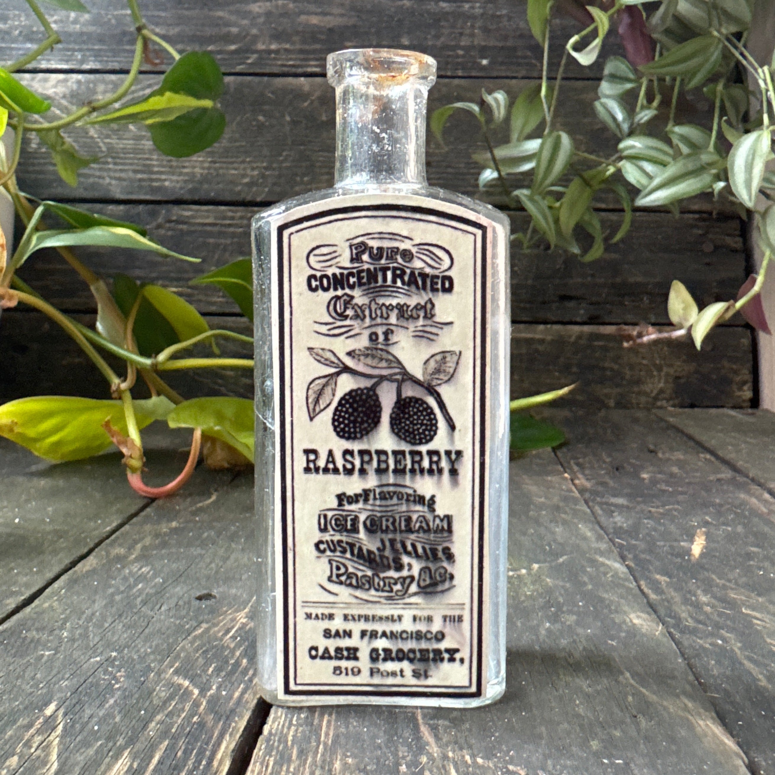 Antique glass bottle with extract of raspberry label