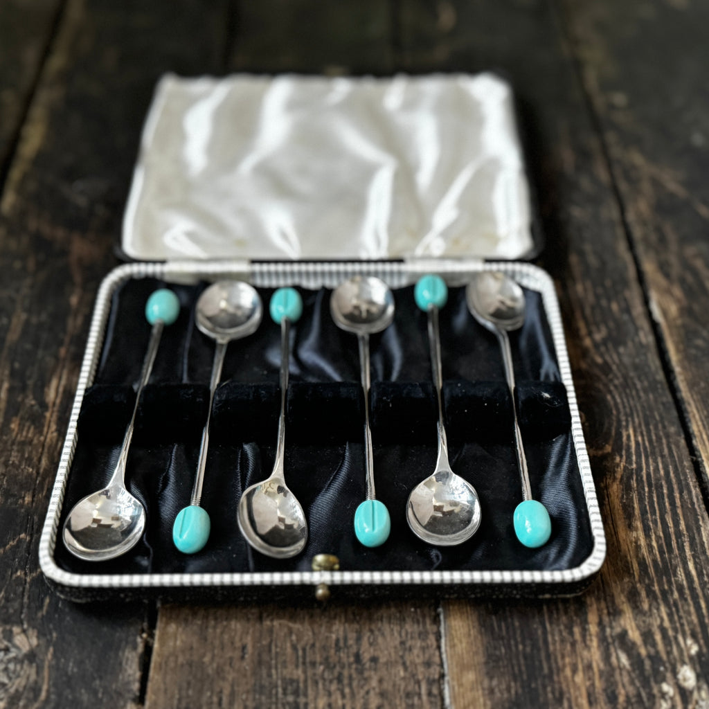 Mid-century coffee spoons with stylised turquoise espresso bean terminals