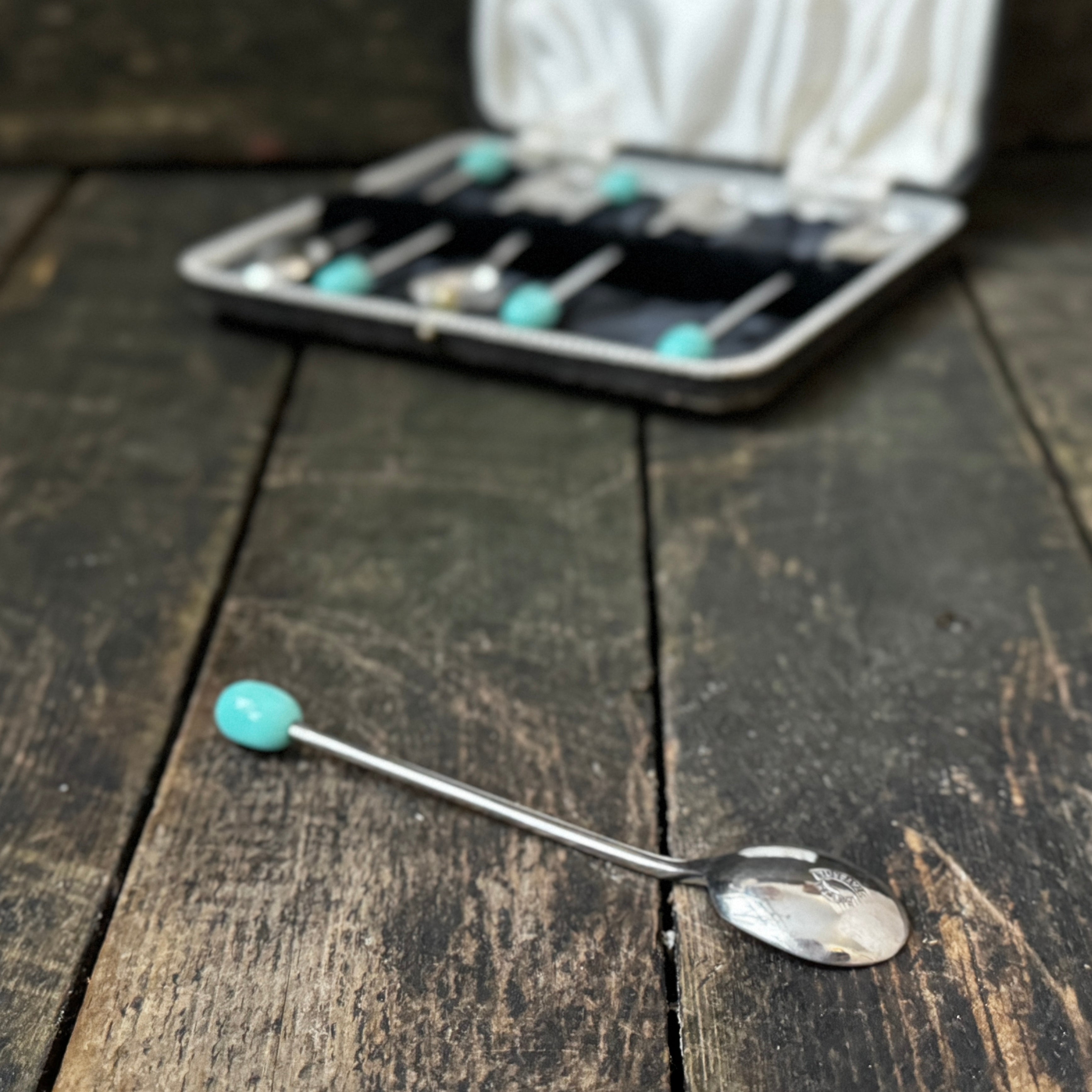 Mid-century coffee spoons with stylised turquoise espresso bean terminals
