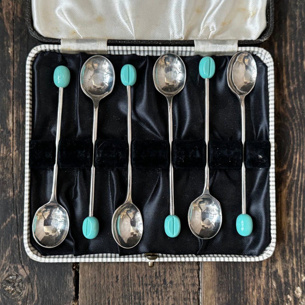 Mid-century coffee spoons with stylised turquoise espresso bean terminals