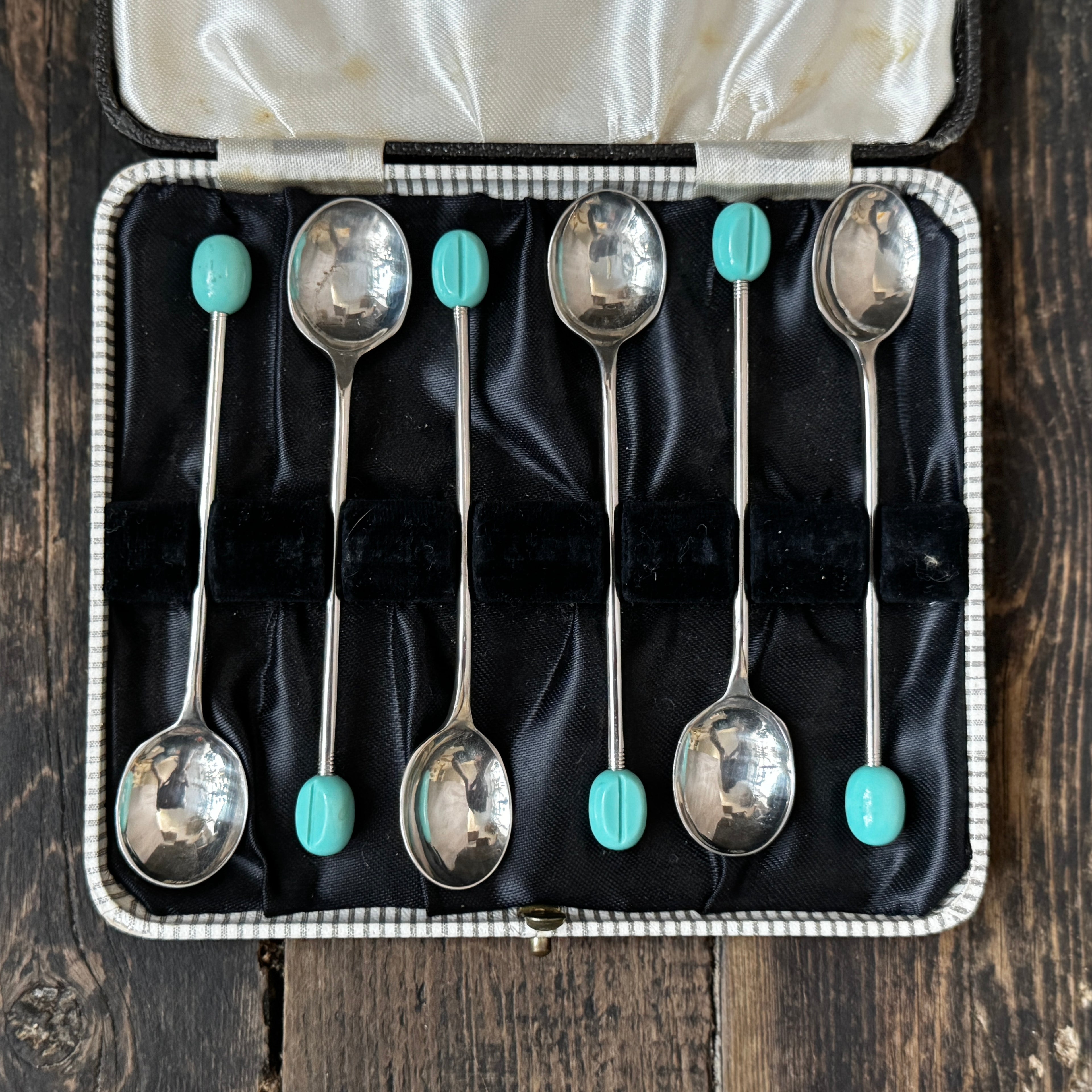Mid-century coffee spoons with stylised turquoise espresso bean terminals