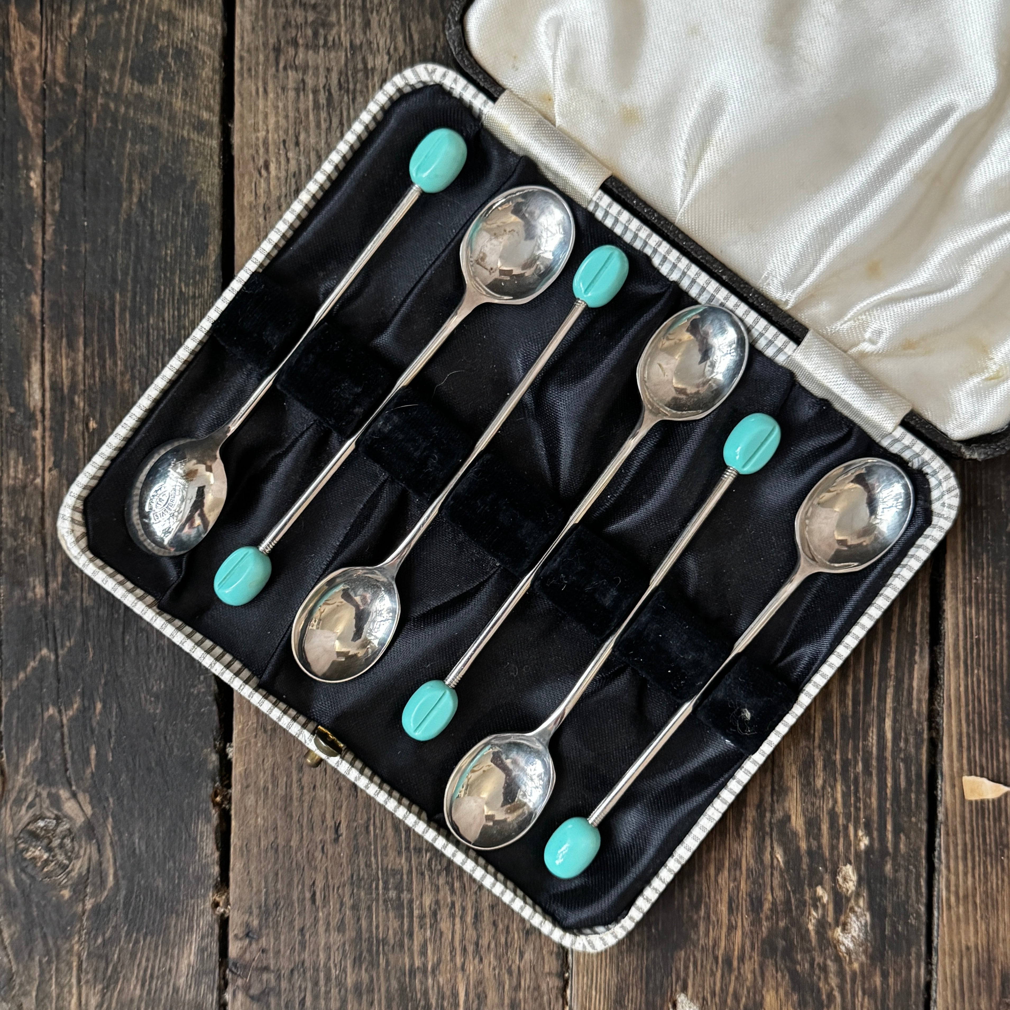 Mid-century coffee spoons with stylised turquoise espresso bean terminals