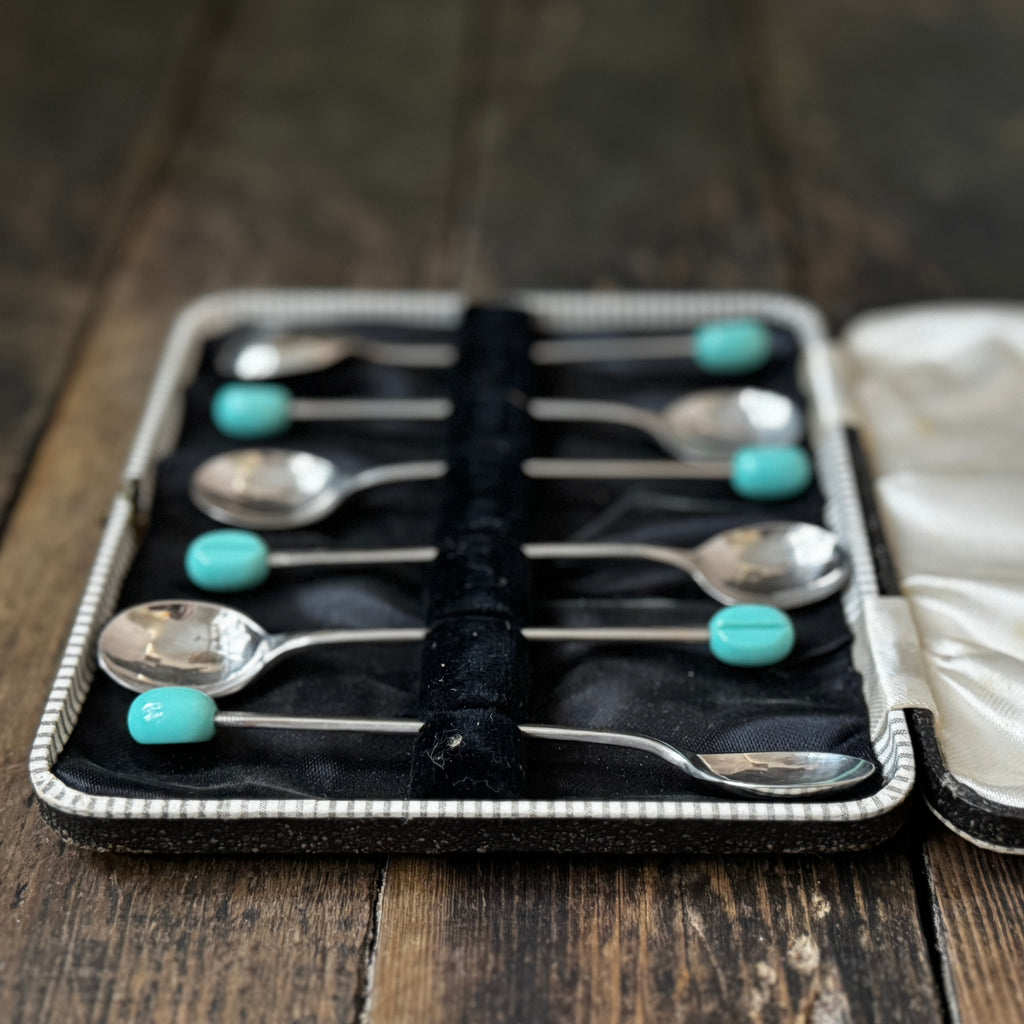 Mid-century coffee spoons with stylised turquoise espresso bean terminals